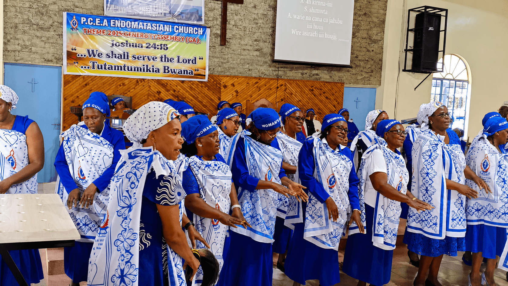 Woman's Guild members in blue uniforms gathered outside church